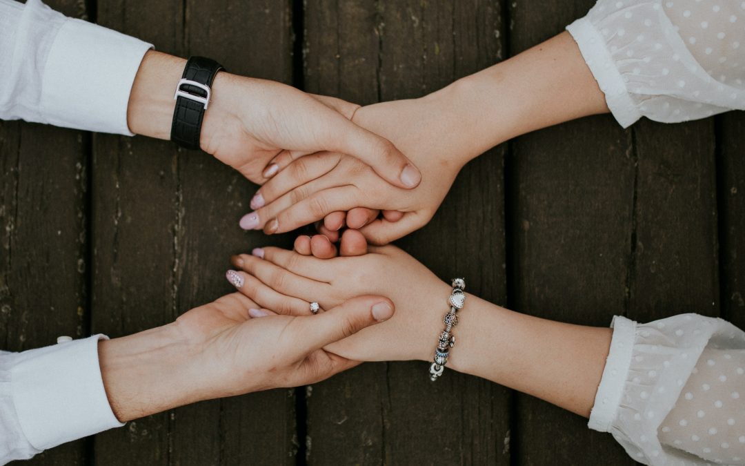 flat lay photography of man and woman holding hands together